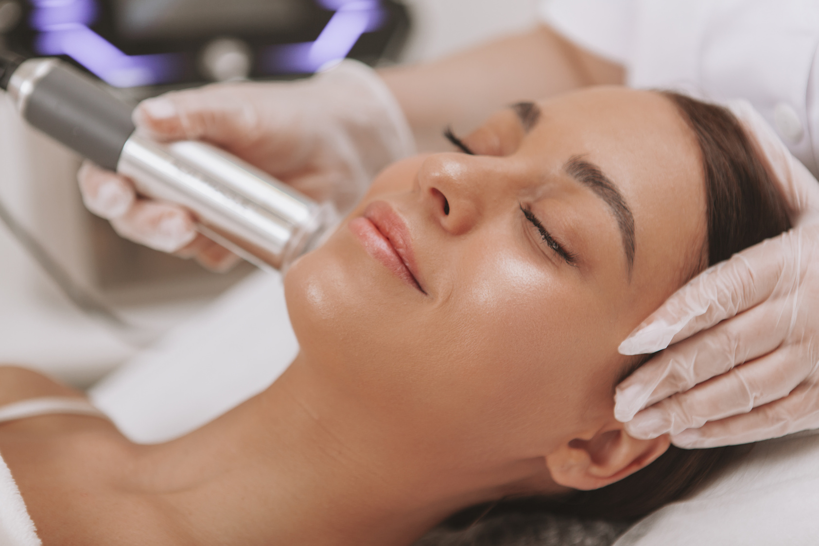 Beautiful young woman getting facial skincare treatment